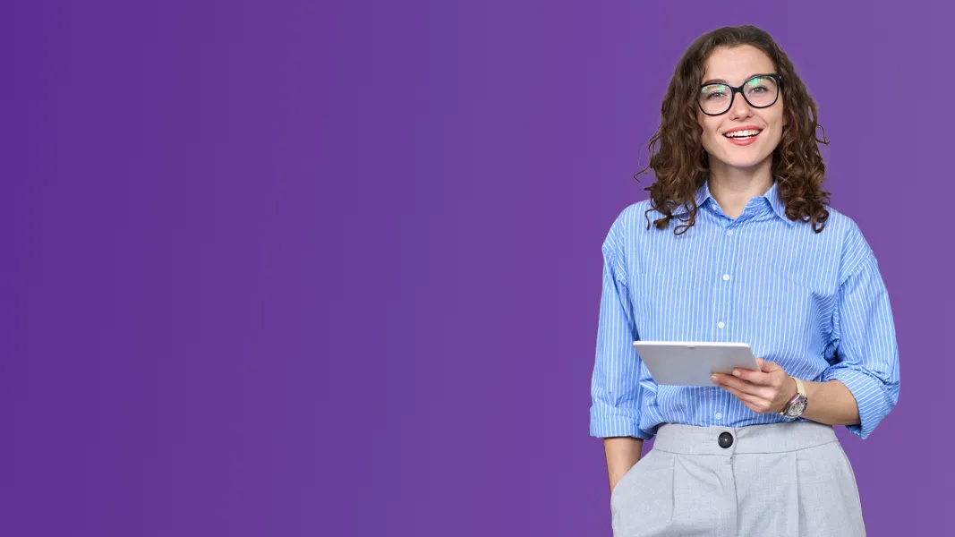 A smartly dressed woman hold a digital tablet in front of a purple background